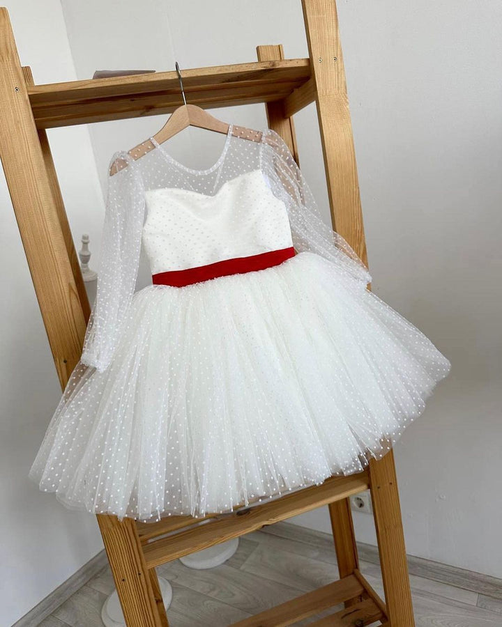 White polka dot dress with red satin sash and statement bow at the back