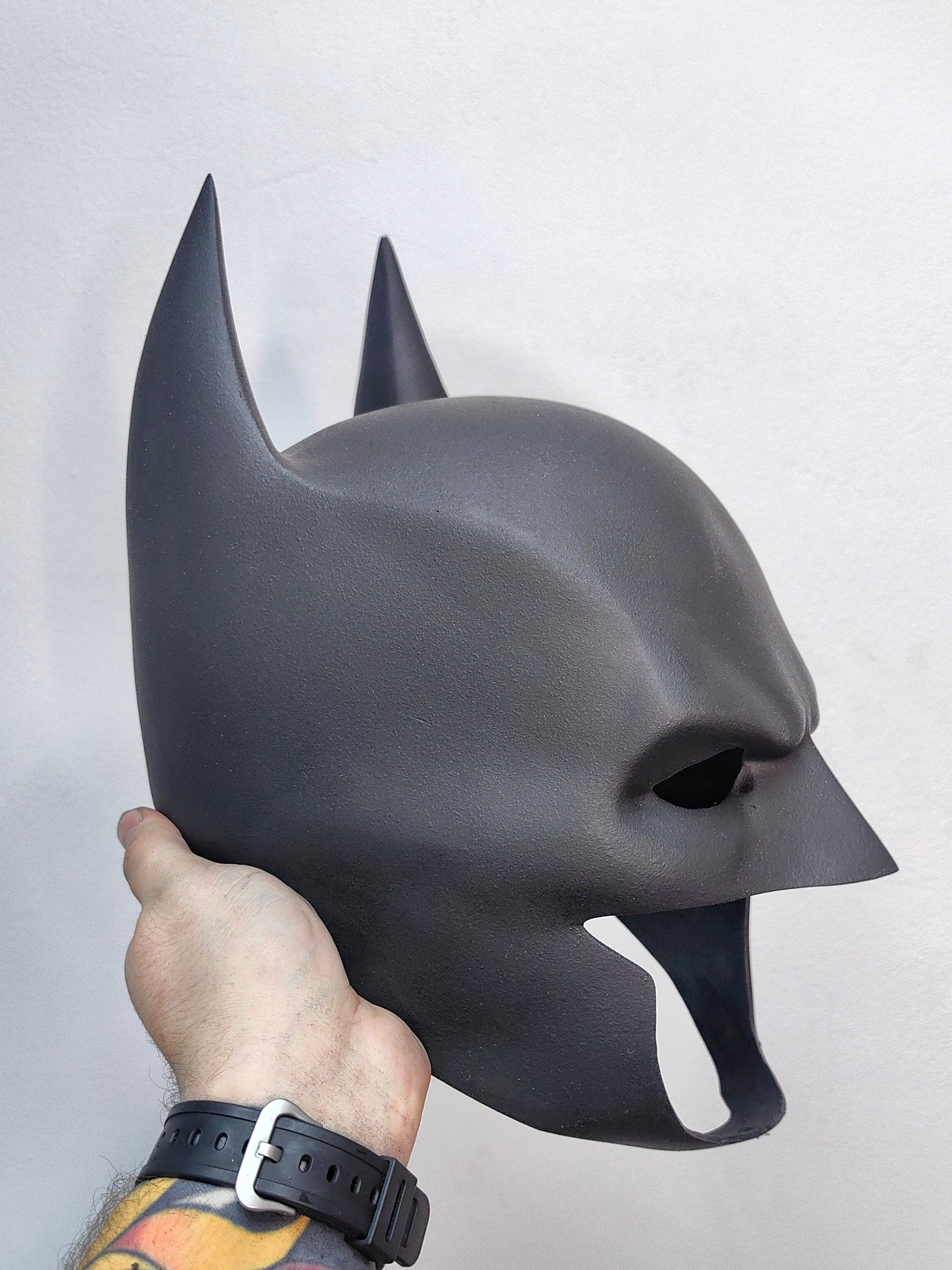 Close-up shot of the Batman mask’s surface highlighting the non-reflective matte black paint and smooth finish.