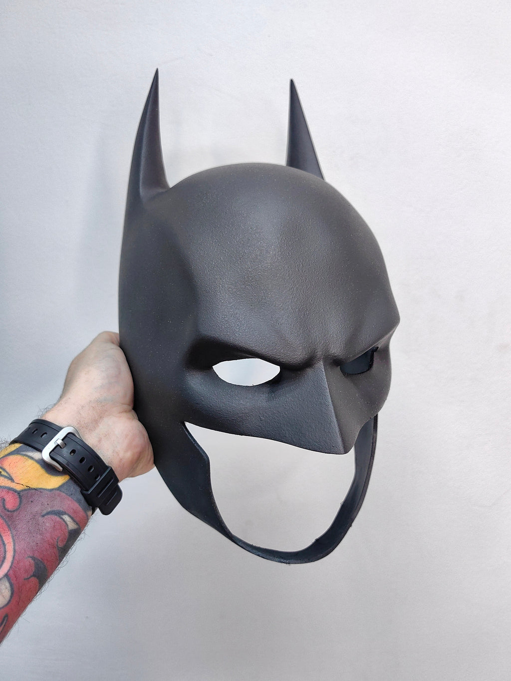 A collectible Batman mask replica, perfect as a display piece for DC fans and man cave decor.