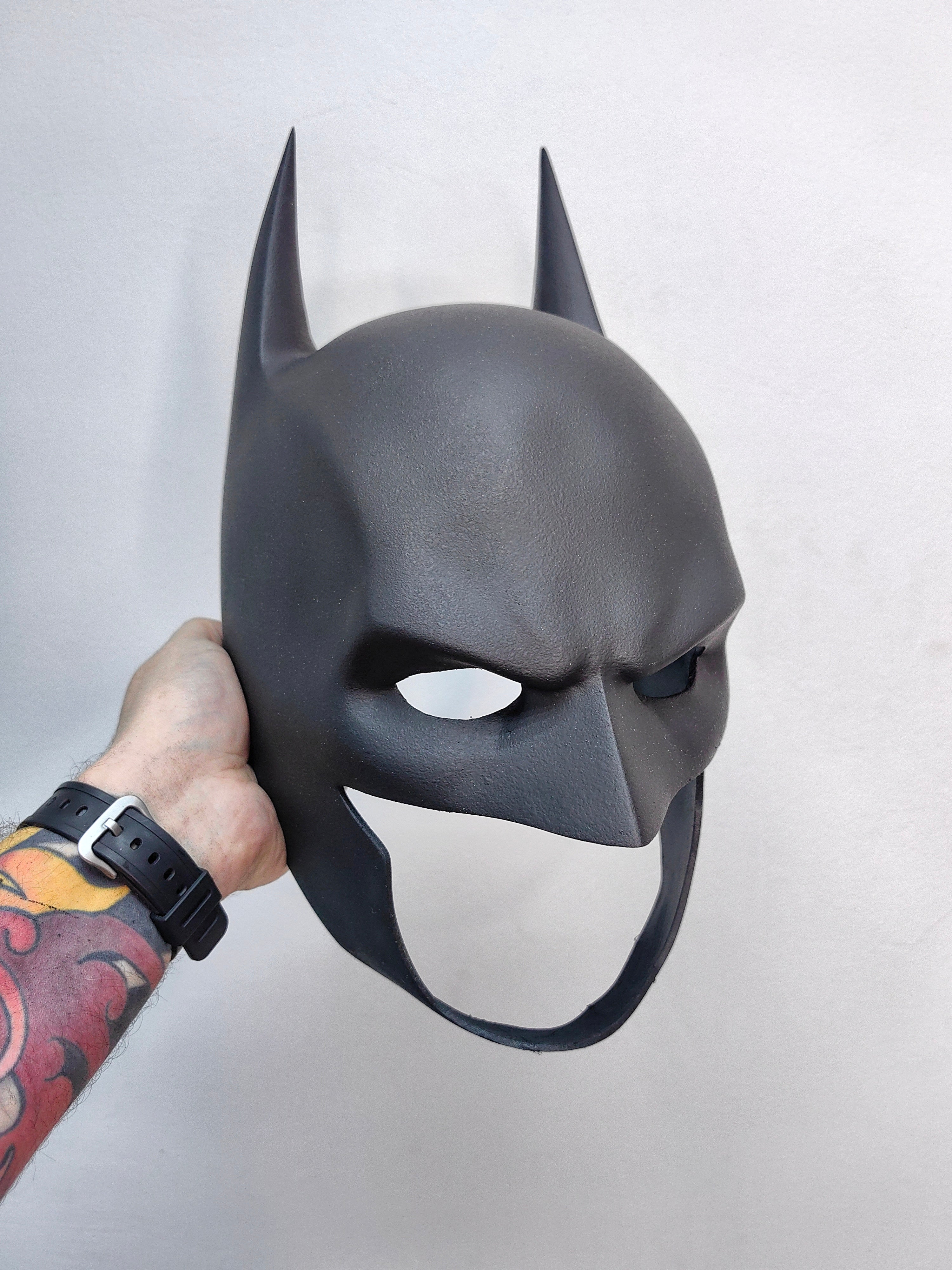 A collectible Batman mask replica, perfect as a display piece for DC fans and man cave decor.
