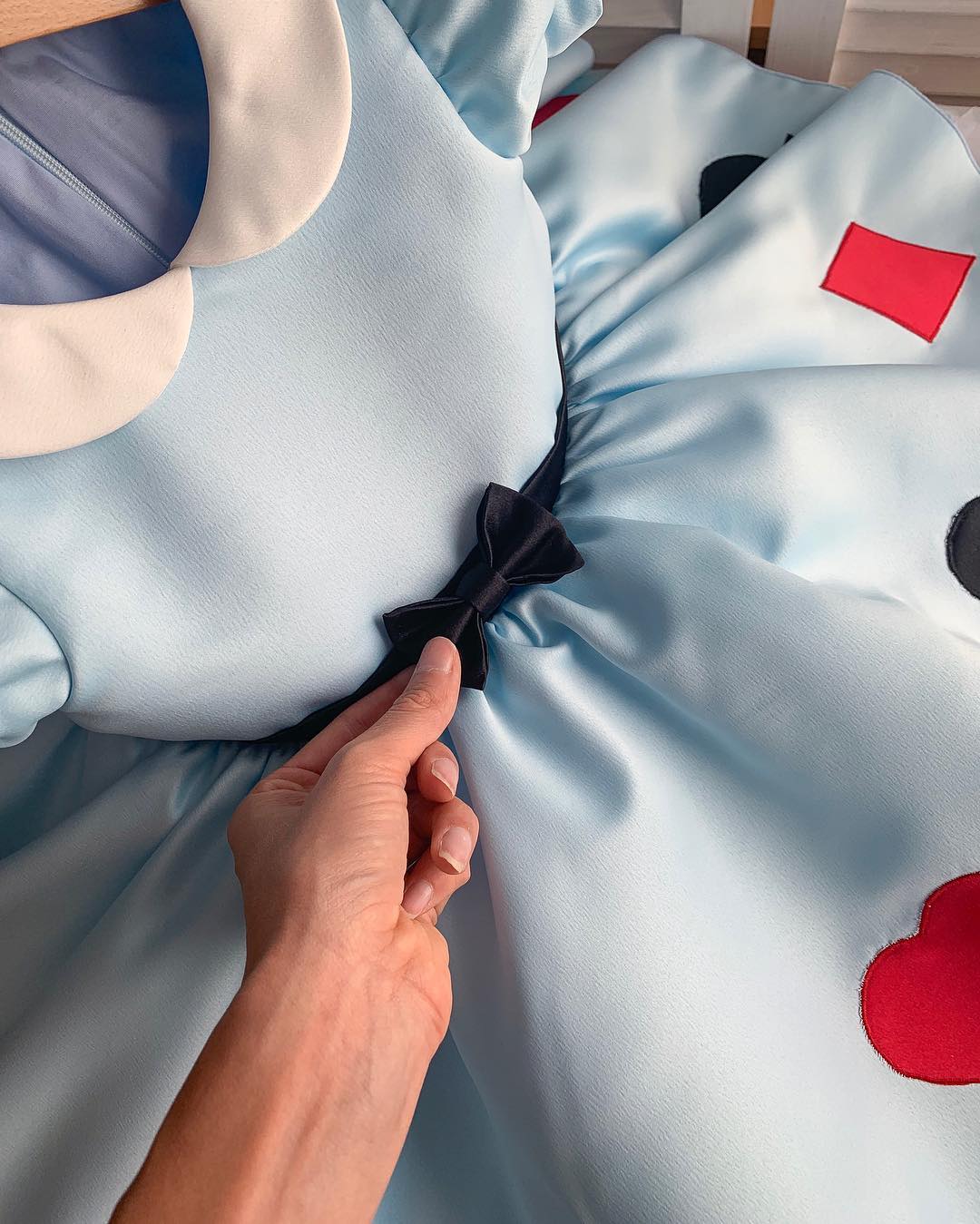 Close-up of lace trim and ribbon detail on Alice in Wonderland princess dress