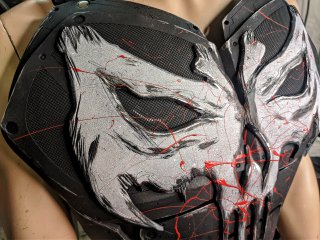 Realistic Punisher superhero armor mounted on a tactical base for professional costuming.